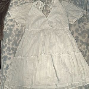 white flows dress with a tie back. long v neck style